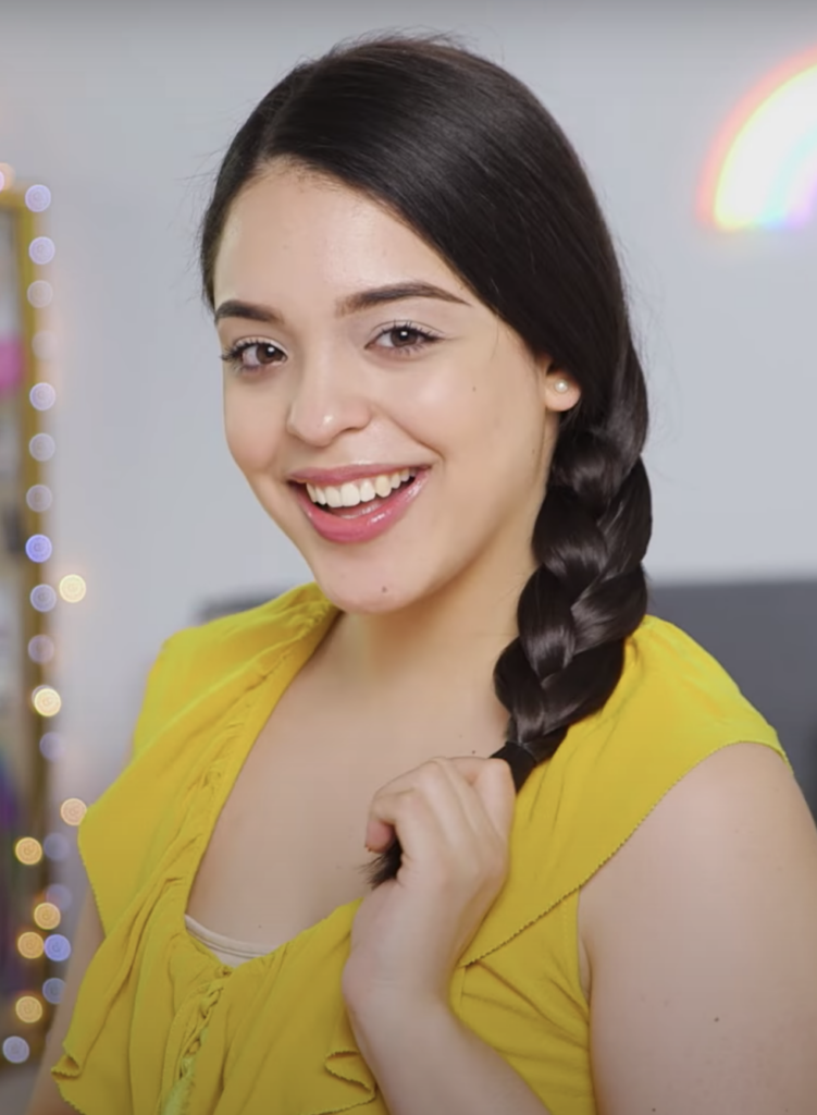 A smiling girl in yellow top showing her Classic Braid - hairstyles for girls