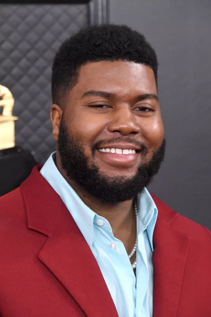 A man in red coat with sky blue shirt smiling and showing his Modern Fade hairstyle A man in red coat with sky blue shirt smiling and showing his Modern Fade hairstyle - men's hairstyles
