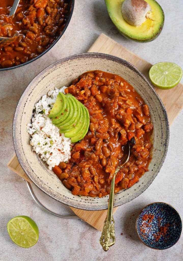 Vegan Chili Sin Carne serves with avocado and rice in a plate - high protein low carb vegetarian foods
