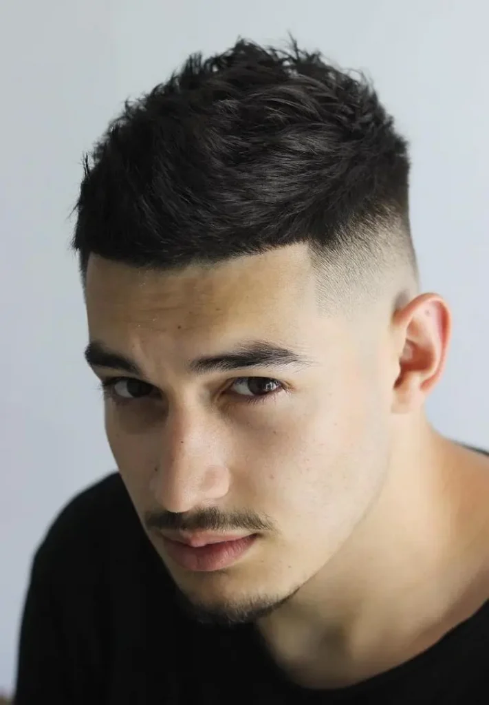 A man in black round neck t-shirt showing his Brushed Up Top with Faded Temple hairstyle - hair cuts for men