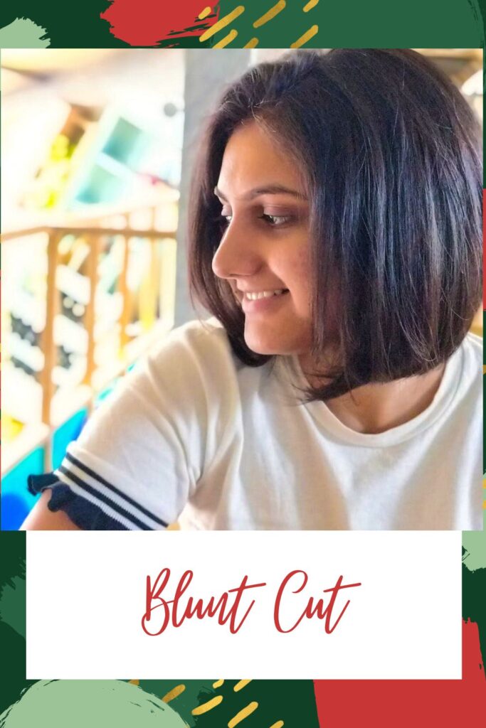 A smiling girl in white t-shirt showing the side view of her blunt cut - Short hairstyles for Indian women