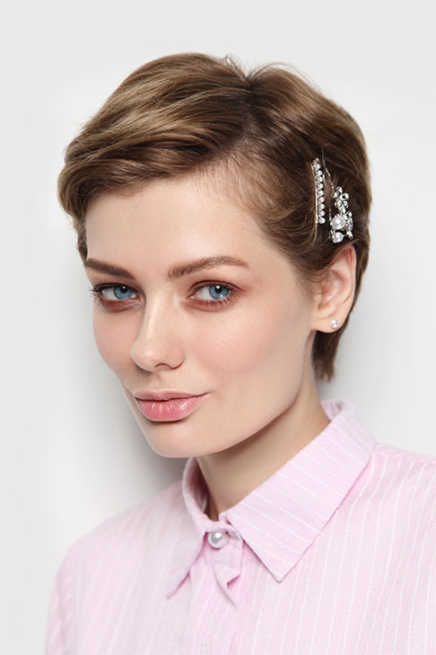 A girl in pink lining shirt showing her Sleek Pinned Pixie hairstyle - short hair