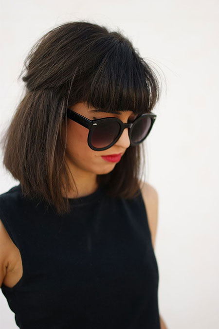 Girl in black cut sleeves top with goggles and Medium Haircut With Bangs - hairstyles for ladies medium length