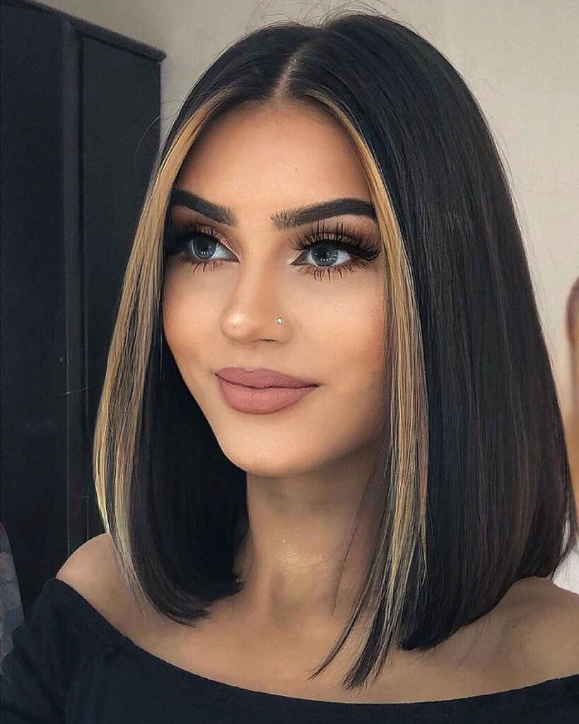 A smiling women in black off shoulder dress posing for camera and showing her Straight Lob hairstyle - haircuts name for females