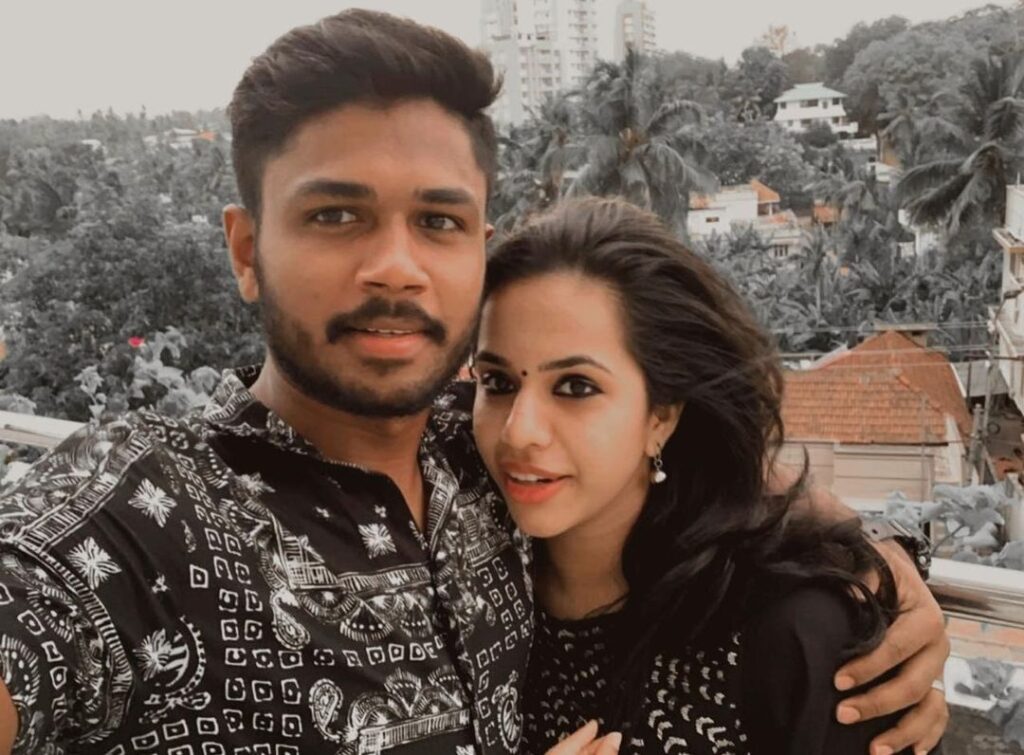 Sanju Samson and Charulatha Samson in matching black outfit posing for a selfie -  indian cricketers wife photos