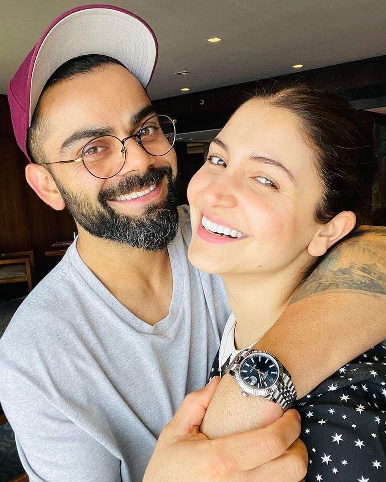Smiling Virat Kohli and Anushka Sharma posing for a selfie - indian cricket team and their wives
