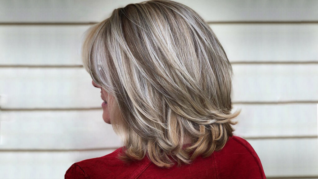 Woman in red dress showing the back view of her Bob with flicked ends hairstyle - best hairstyles for young ladies