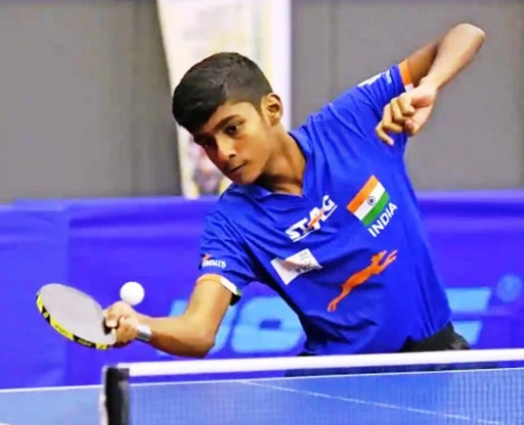 Vishwa Deenadayalan in official Indian sports t-shirt playing table tennis - bollywood celebrities who passed away in 2022
