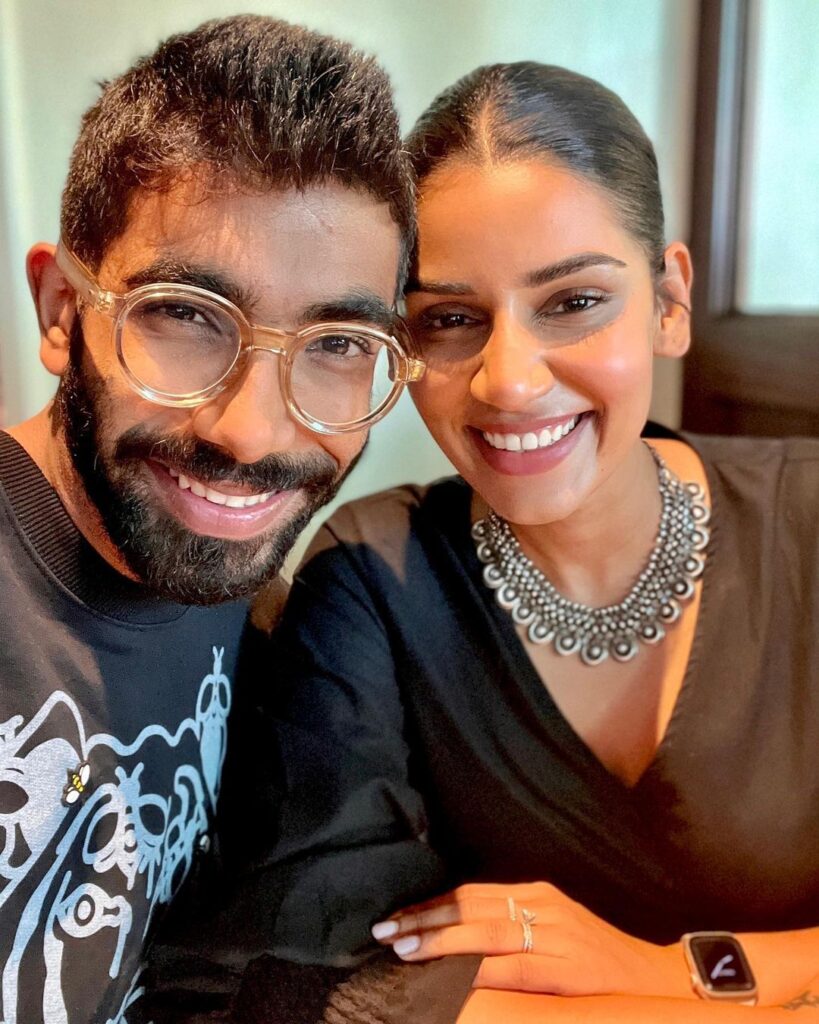 Smiling Jasprit Bumrah in spectacles and Sanjana Ganesan posing for a selfie - indian cricketers wife