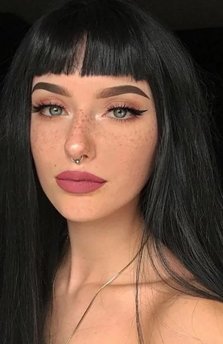 Women in pink lipstick and nose ring with Long Black hair with Bangs - haircuts for straight long hair