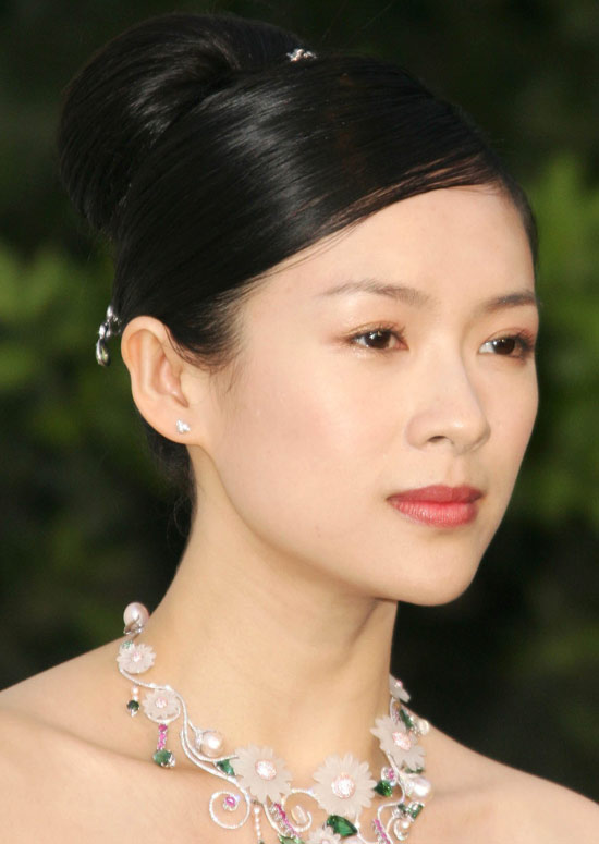 A women wearing necklace and pink lipstick showing her Sleek and Smooth Bun hairstyle - professional hairstyles for women