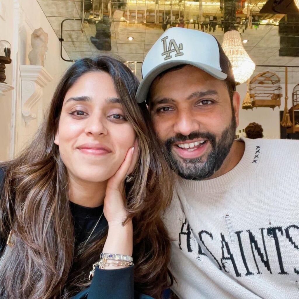 Smiling Rohit Sharma and Ritika Sajdeh posing for a selfie - indian cricket team and their wives