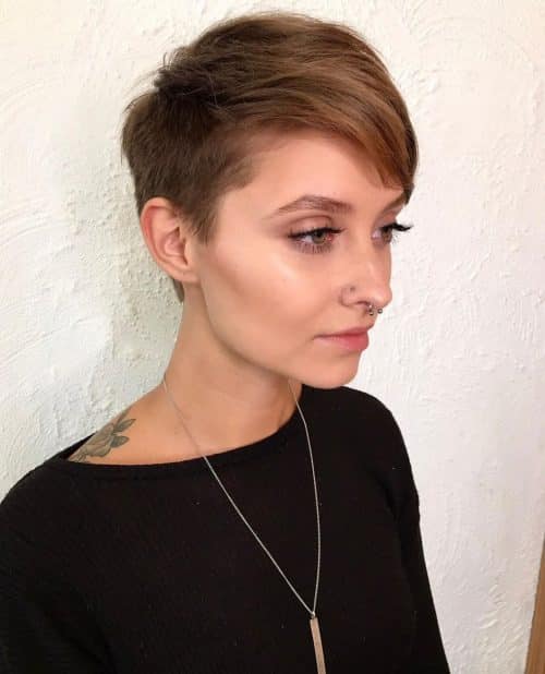 A women in black top and silver chain in her neck showing the side view of her Pixie Cut hair - women hairstyle