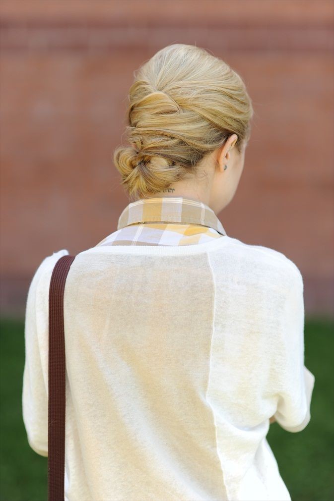 A women in white pullover with check shirt showing the back view of her Woven Bun hairstyle - hairstyle for ladies