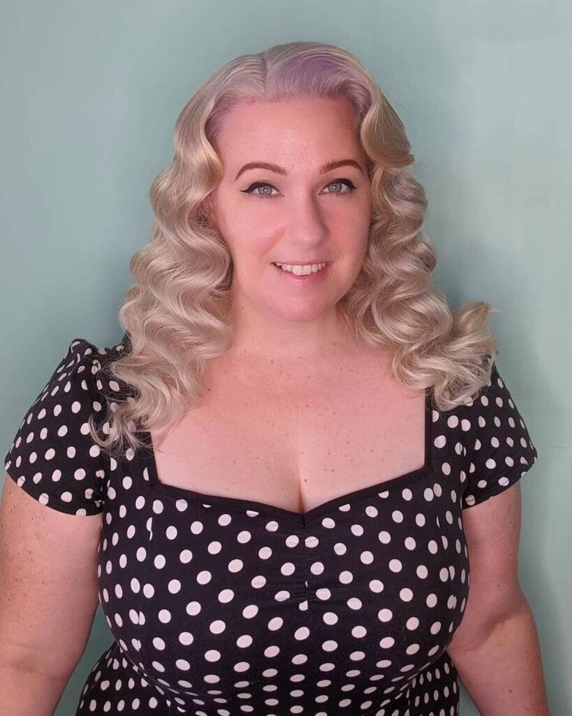 Woman in black and white polka dots dress  with Retro curls - 2022 haircuts female