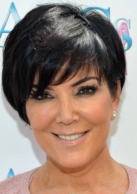 A smiling women in pink top and stud earrings showing her Volumized Bob with Fringes - professional hairstyles for women