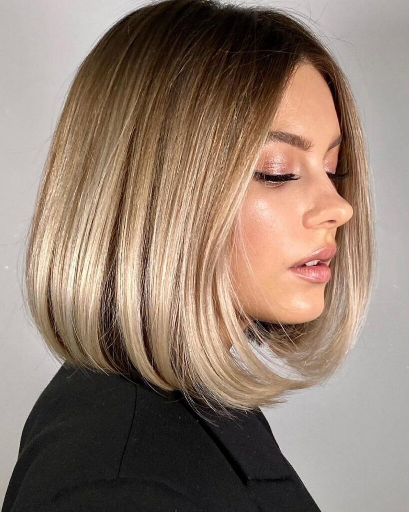 A women in black dress showing the side view of her Smooth Bob hairstyle - short hair