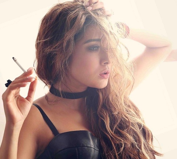 Tina Dutta in black strappy dress and ,messy hair holding a cigarette - tv serial actress who smoke in real life
