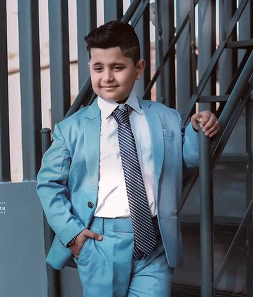 Boy in blue suit and black and white lining tie with Short High Volume Hair - types of haircut in India