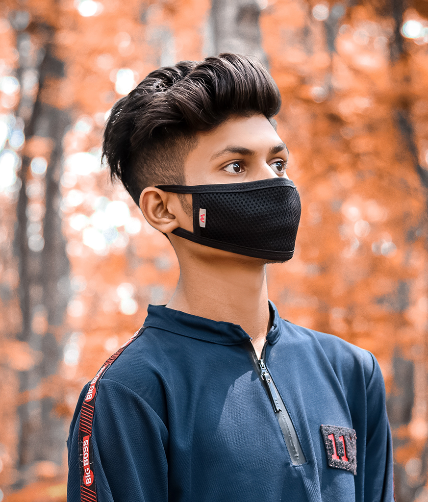 Boy in blue t-shirt and mask with slicked back long hairstyles - types of haircut in India