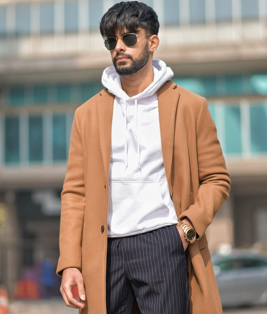 Man brown coat with white inner with googles and fringe haircut - hairstyles for Indian boys