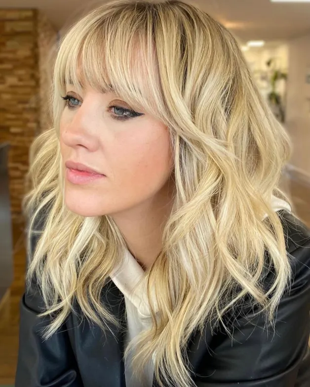 Woman in black jacket with off white jacket  and Wispy Bangs for Medium Hair - best simple hairstyles