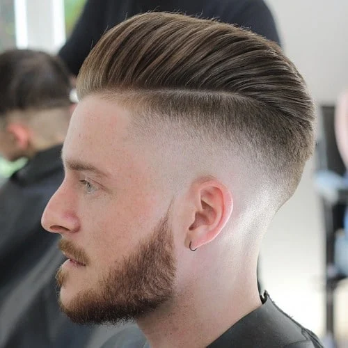 Man in black outfit showing his Pompadour hairstyle - haircuts for men fade
