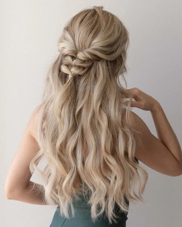 Woman showing the back view of her Voluminous Easy Long Braided Hair - hairstyle for long hair on jeans top