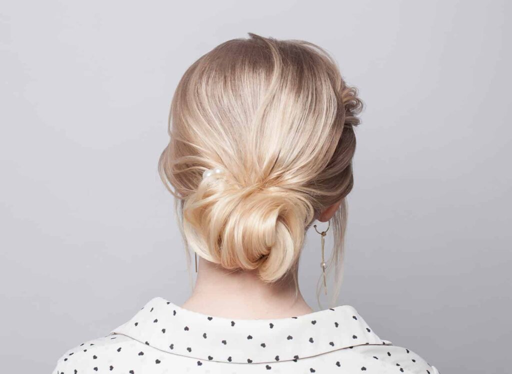 Woman in white printed shirt and The Looped Bun hairstyle - hairstyle for girls