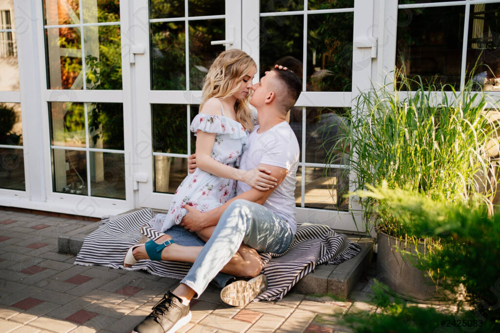 Couple sitting in the backyard and getting closer - places to make out