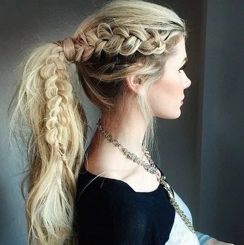 Woman in black dress with silver necklace and The Braided Pony hairstyle - long haircut 2022 women