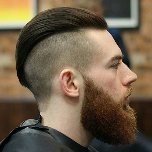 man in black outfit and Slicked Back Undercut with Beard hairstyle - haircuts for men
