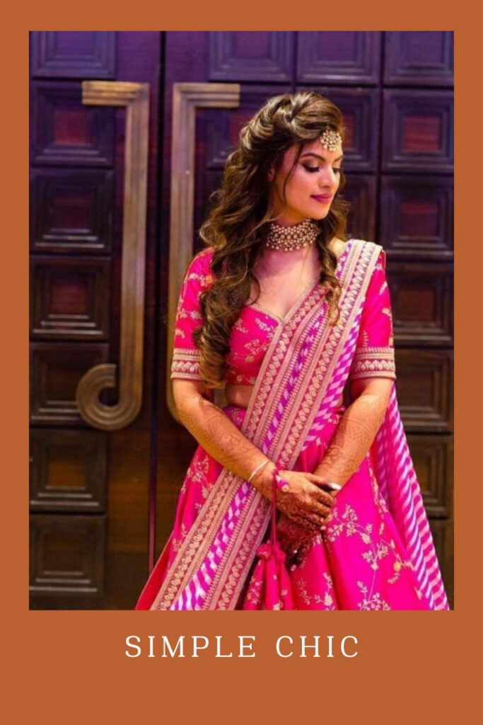 Woman in pink lehenga with matching jewellery and Simple Chic hairstyle - Curly Hairstyles for lehenga