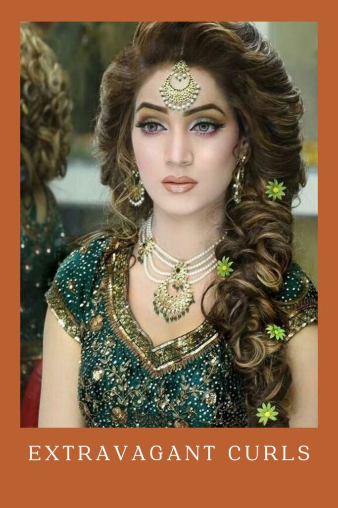 Woman in green lehenga with golden and pearl jewellery with Extravagant Curls - curly hair for lehenga