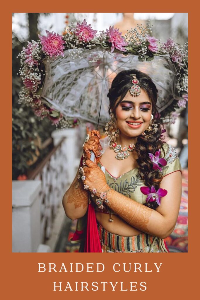 Woman in bridal look holding floral umbrella with Braided Curly Hairstyle - Curly Hairstyles for lehenga