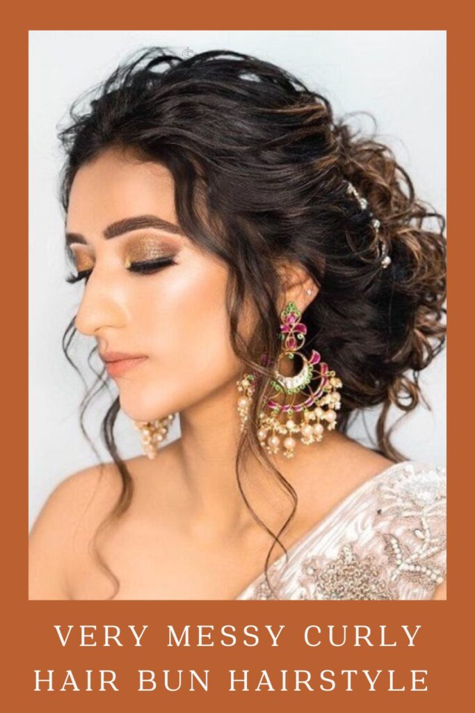 Woman in off white lehenga and multicolor danglers with Very Messy Curly Hair Bun Hairstyle - open hairstyles for lehenga