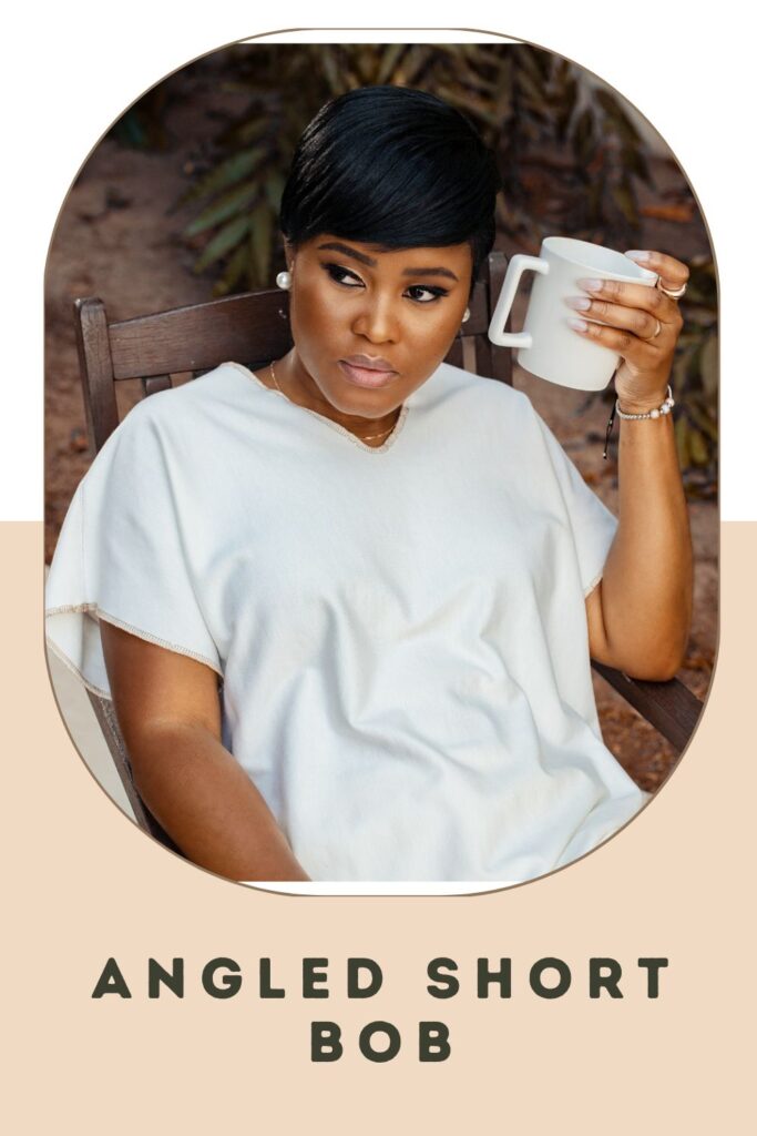 Woman in white top and holding white mug sitting on a chair - short hair up ideas