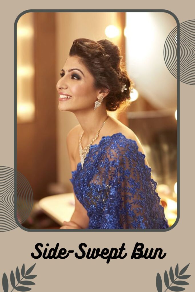 Smiling woman in blue net saree and golden jewellery with Side-Swept Bun Smiling woman in blue net saree and golden jewellery with Side-Swept Bun - Indian hairstyle for short hair for wedding
