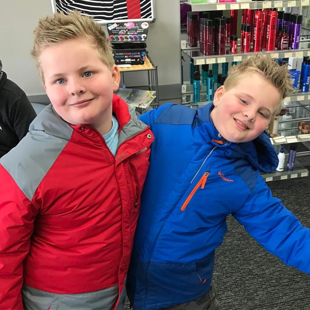 a smiling boy is showing his Buzz Fade Buzz Fades