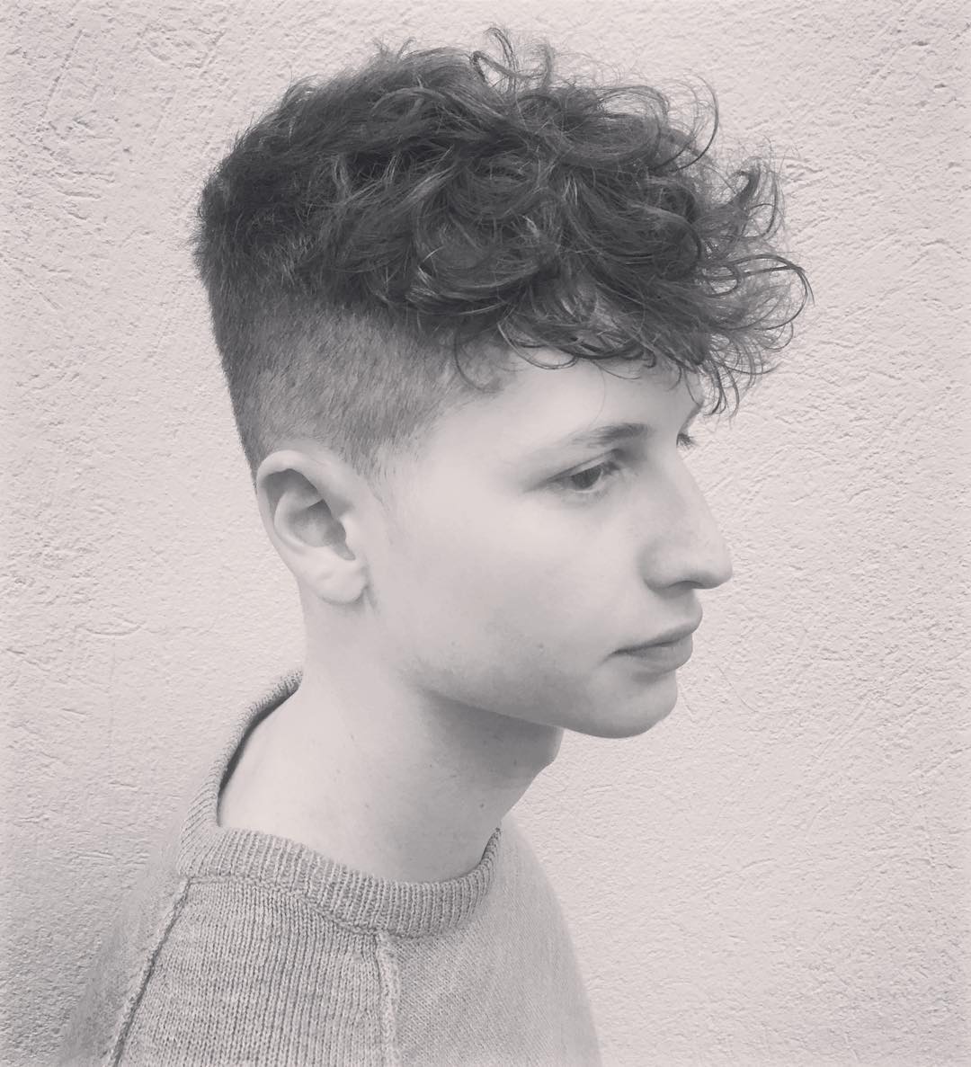 A boy in grey shirt showing his Wavy Quiff + Short Beard hairstyle Wavy Quiff